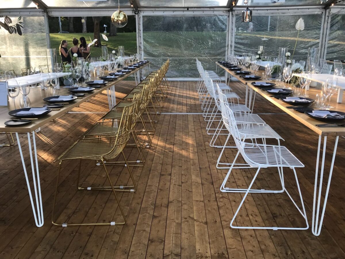 A mix of White & Gold Arrow Chairs with Hairpin Dining Tables